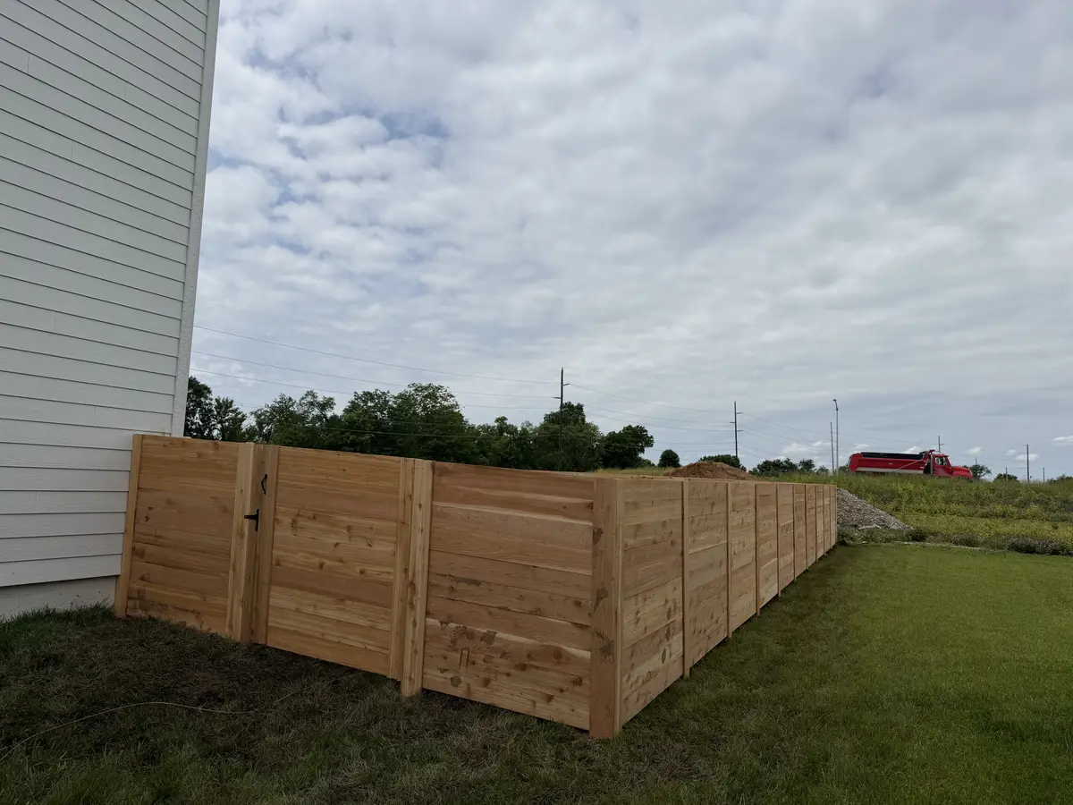 New horizontal cedar privacy fence with gate on residential lot — Liberty MO